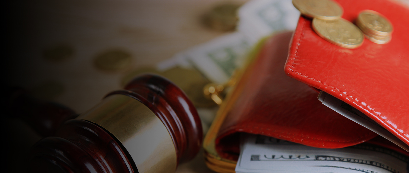 Gavel and money coins on wooden background